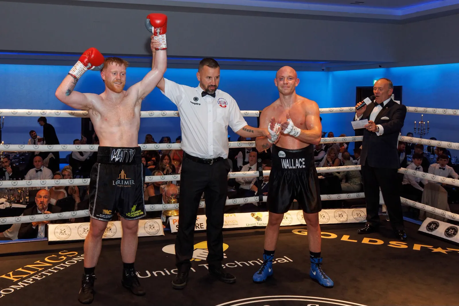 The referee raising Matthew's hand after his pro debut against Steven Wallace