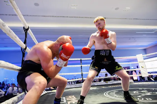 Matthew stalking an opponent who crouches behind his gloves