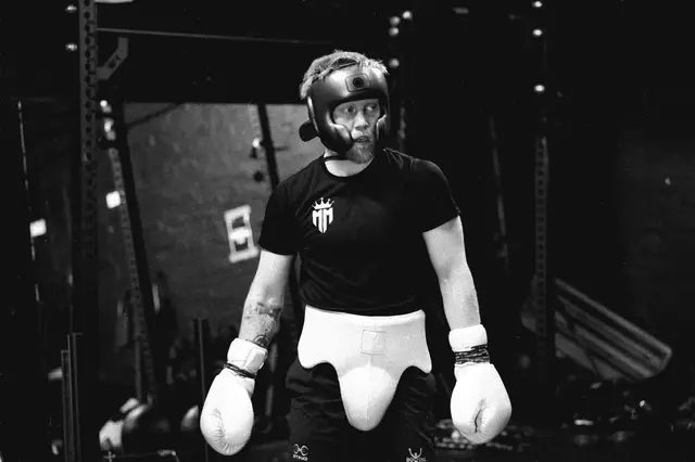 Matthew in a headguard and sparring gloves